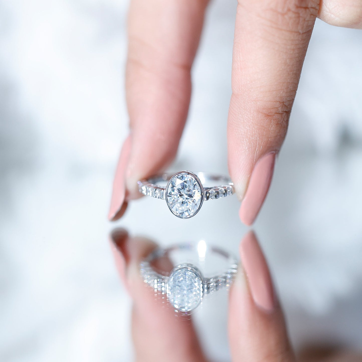 Bezel Set Moissanite Oval Engagement Ring with Side Stones